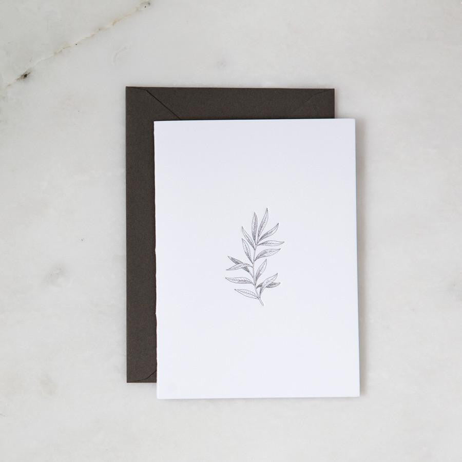 Our botanical card is featured. A minimalist, monochromatic sketch presents a sprig of delicate leaves centered on a stark white rectangular card, set against a marble-like backdrop.