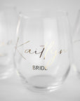 Personalized bridal party wine glasses with names and titles like Bride, Kaitlyn, in script.