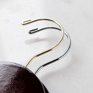 Two dark wooden hangers, gold and silver hooks