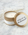 4 oz gold tin candle, lid reads "will you be my bridesmaid?" in black script on white background. Side reads "lavender"