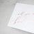 White envelope size card (approx. 3.5" x 5"), reads, "Will you be my bridesmaid?" in rose gold text.