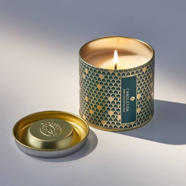 Soy wax candle in a patterned green and gold foil tin topped with an embossed lid. Eucalyptus, balsam fir, and pine scented. Soy wax, metal, 7 oz, gold text.