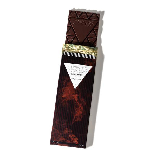 Whiskey flavored dark chocolate bar in a red smoke graphic packaging, gold foil interior wrapper. White label, with black text. 