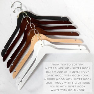 Hanger color variations. Matte black with silver hook, Dark wood with silver hook, Dark wood with gold hook, medium wood with silver hook, light wood with silver hook, white with silver hook, white with gold hook