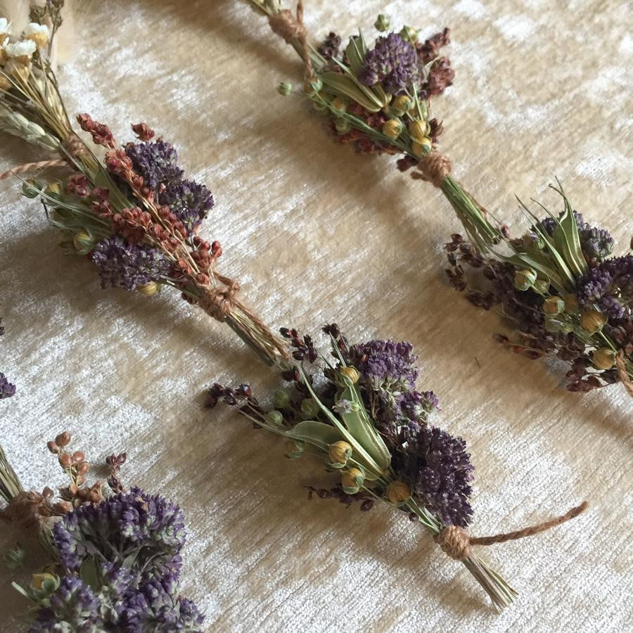 Lavender dried floral bundle, featuring five of them set against a cream background. 