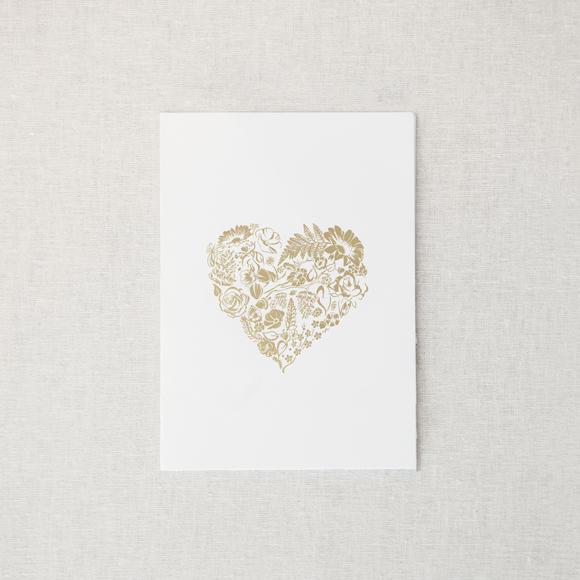 Our floral heart card is featured  embossed on a white card in a beige background. 