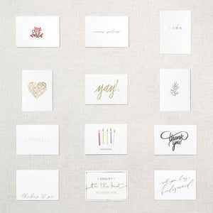 Display of twelve white cards. Gold floral heart, pink xoxo, gray branch, white congrats embossed, happy birthday under five candles, thank you in gray script, thinking of you, I couldn't tie the knot without you in gold, Yay! in gold script, will you be my bridesmaid rose gold, will you be my maid of honor rose gold, will you be my matron of honor rose gold