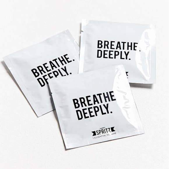 three happy spritz breathe deeply essential oil towelettes shown on white background