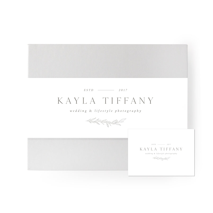 White/Cape cod colored gifting box, with a white band around the middle of the box, customer brand printed in the center. White card with client graphic printed in the center. 