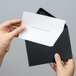 Custom white card printed with client logo. Black envelope.