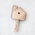 leather house shaped key topper tan in color made of leather shown on wooden key and white background