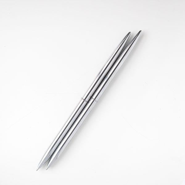 Two minimalist silver pens that have a round shape are featured on a white background.