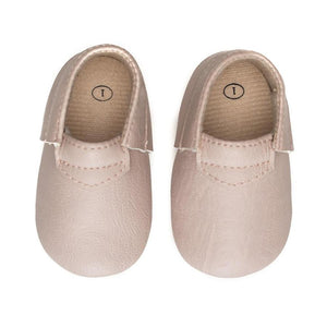 Top view of light pink baby moccasins with size stamped inside the heel