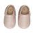 Side view of light pink colored baby moccasins
