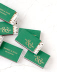  Eight custom matchboxes in chroma leaf in the image, some open showing white tip matches, the matchboxes are personalized in shiny gold with Mr & Mrs and Rachel & Ryan Groeneweg.