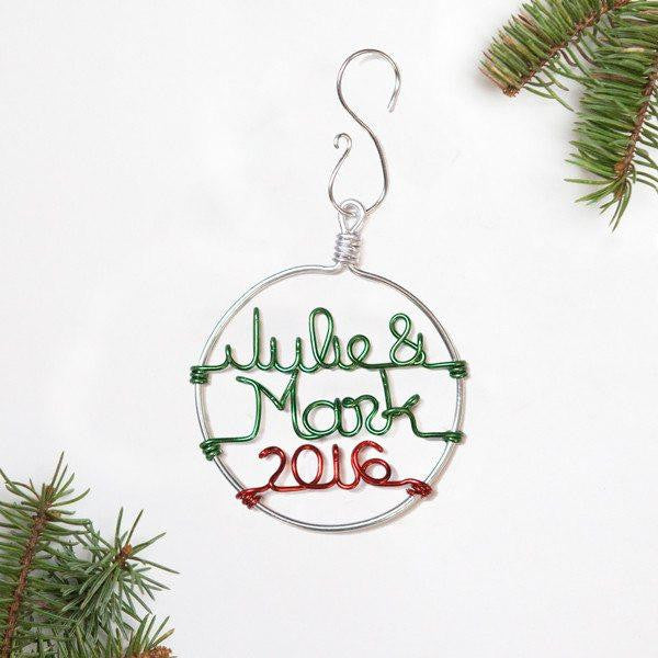 Personalized couple's Christmas ornament in silver outline that says Julie & Mark in green aluminum wire and 2016 in red aluminum wire. 