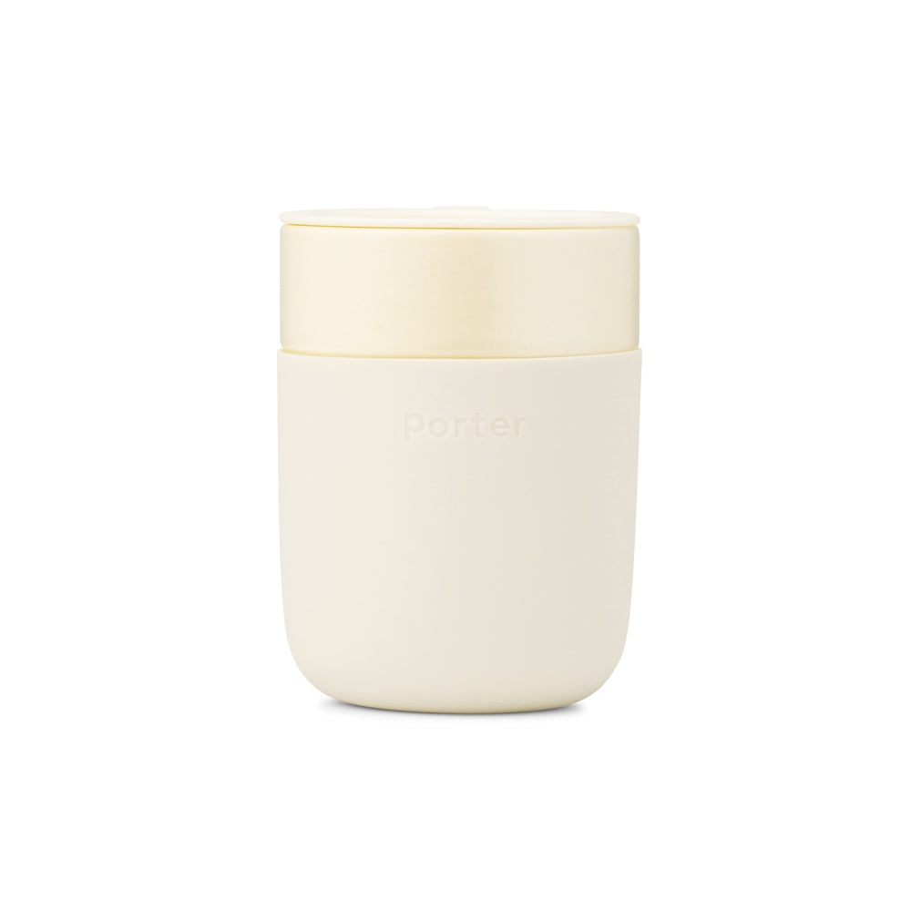 Cream colored ceramic tumbler with protective silicone covering.
