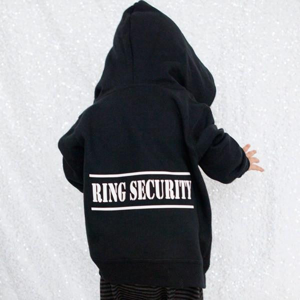The back of a Ring Bearer Hoodie in black with the word Ring Security on the back on a white background, and a child is wearing it.