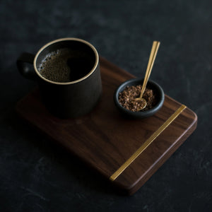 Make and stow serving board with rustic mug and small dish.