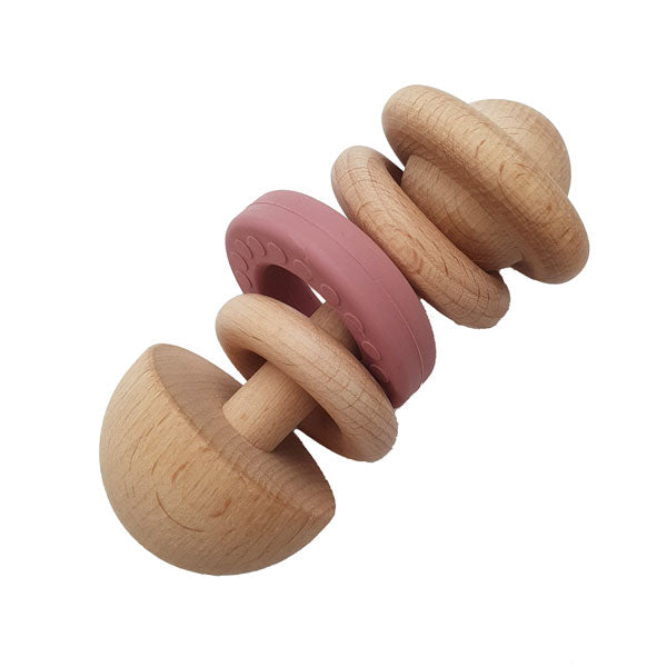 Light wood baby rattle with two wood ring and one pink silicone ring.