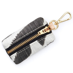 Black and white zebra design pouch with gold zipper and keychain hook
