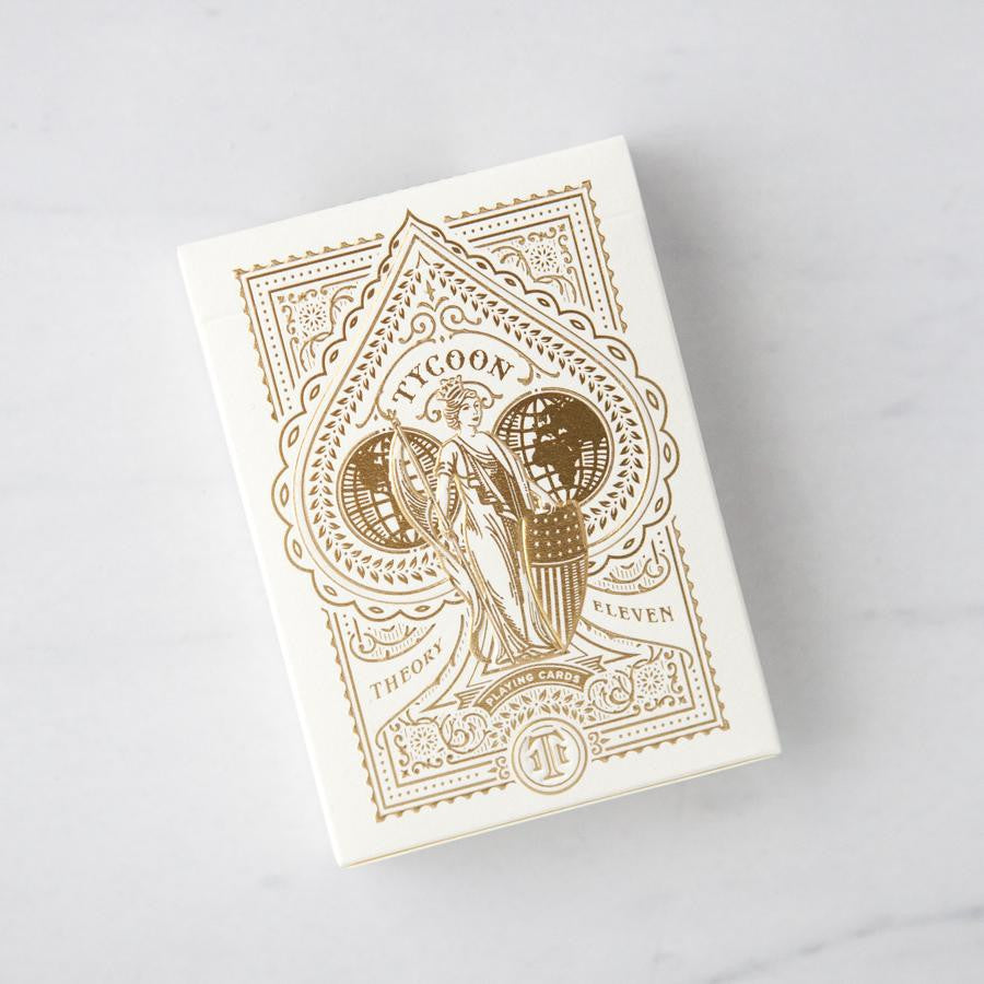 ivory tycoon playing cards with gold stamped design shown on white background