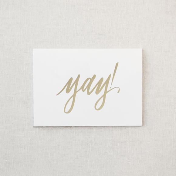 White greeting card with gold foil "Yay!"